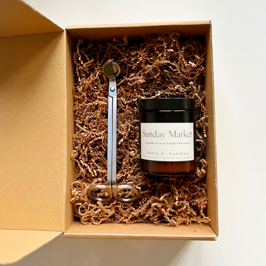 Eine Duftkerze edel verpackt zusammen mit einer hochwertigen Dochtschere – das perfekte Geschenk für Kerzenliebhaber.